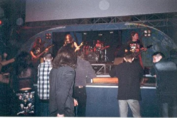 Совместный концерт в клубе "Планетарий" (Рязань) с  местными Necromayhem 6 мая 2004 года. Для тех, кто не в курсе - Владимир (drums) играет со сломанной ногой.