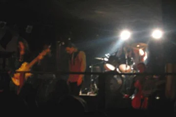 Абстрактный снимок группы из далека.
Выступление ~ SILVIA ~ на H.I.M. party в клубе "Релакс" 18 июня 2005